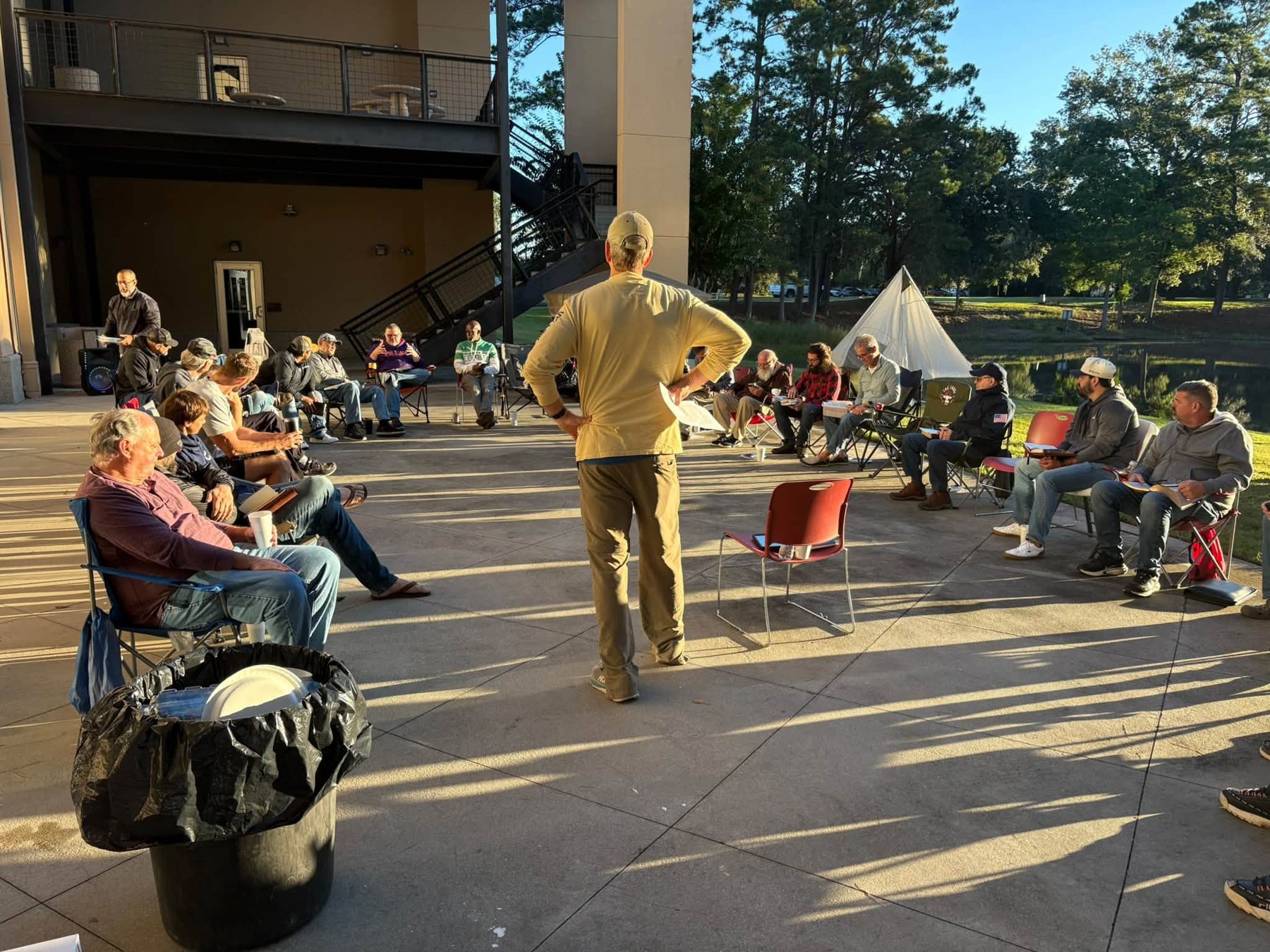 The Forge gathering outdoors with chairs arranged around a speaker